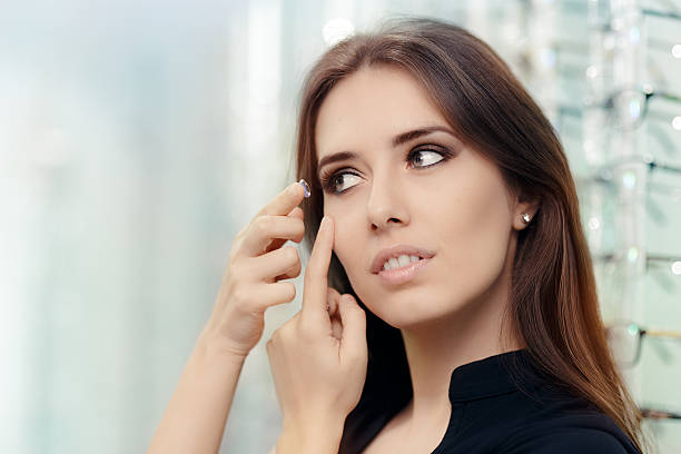 Woman with Cosmetic Colored Lenses in Optical Store