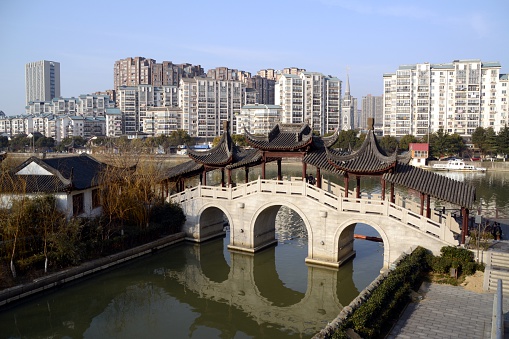 Wuxi, China - February 9, 2016: Bridge at Yunhe park, along the Grand canal of China in Wuxi, Jiangsu. People sightseeing the site.