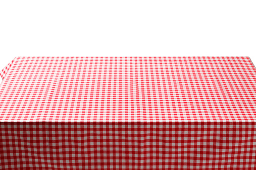 Red and white plaid tablecloth background. Picnic table, covered with a checkered tablecloth. Ideal to position products on and place in the foreground of any image.