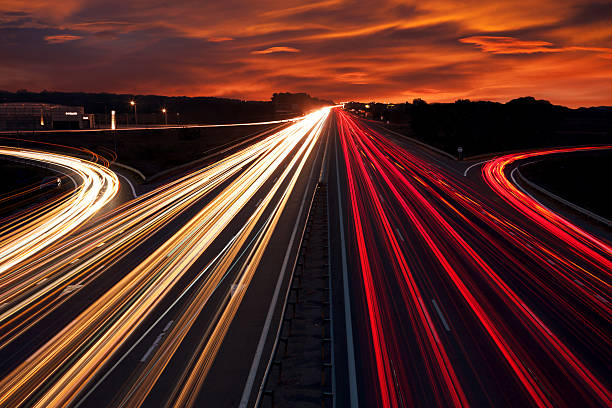 istock Speed Traffic - light trails on motorway highway at night 521023121