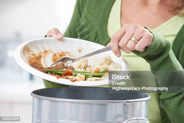 Woman Scraping Food Leftovers Into Garbage Bin Stock Photo - Download Image Now - Food, Garbage, Leftovers