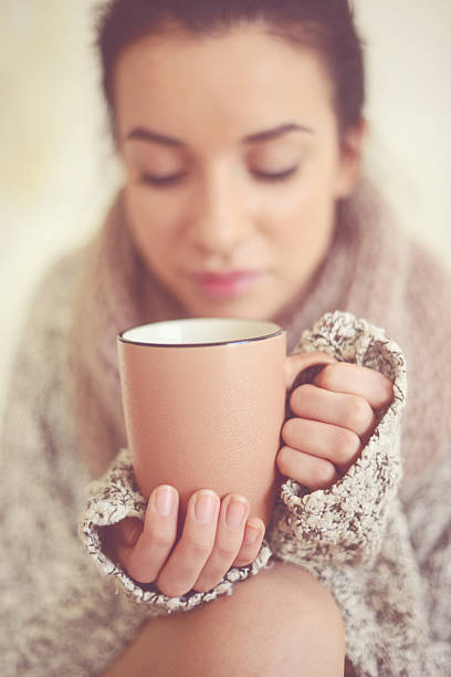 istock Female hands hold a coffee cup closeup 521024943