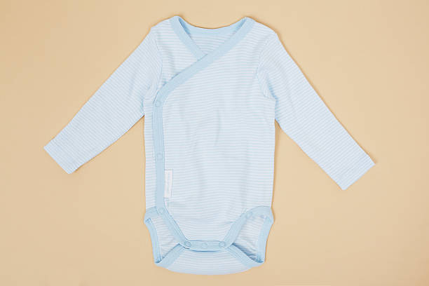 istock Blue babywear on yellow background 521025947