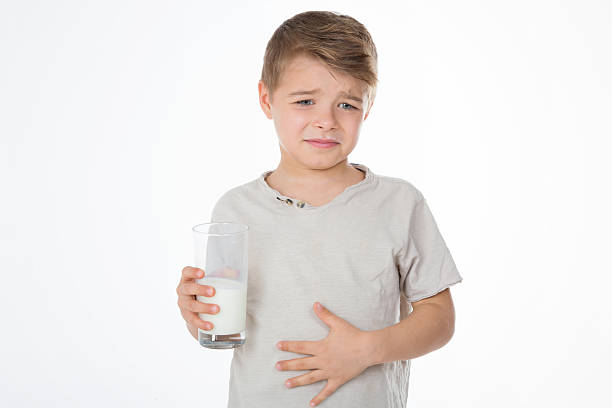 young boy has a bellyache child with painful expression after drinking milk little boys blue eyes blond hair one person stock pictures, royalty-free photos & images