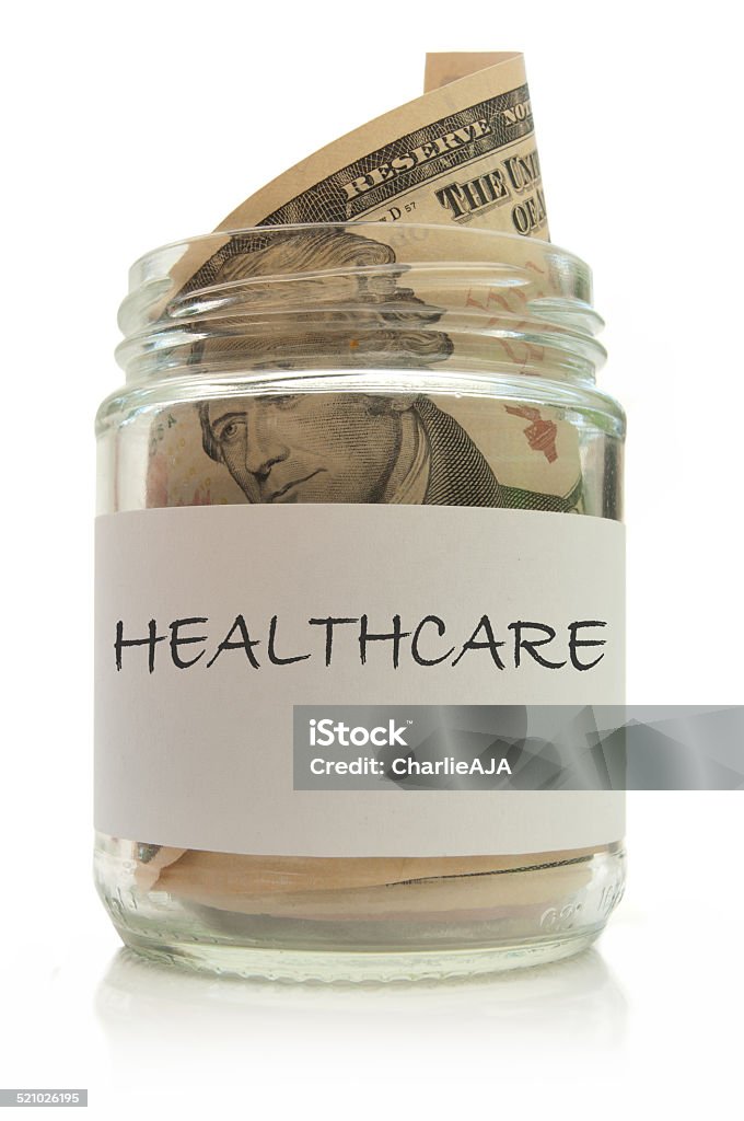 Healthcare fund Jar full of dollar notes over a white background Currency Stock Photo