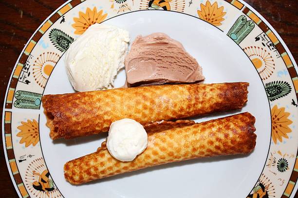 Homemade waffle tubes A close-up photo of Homemade waffle tubes on the plate ice cream with wafer rolls stock pictures, royalty-free photos & images