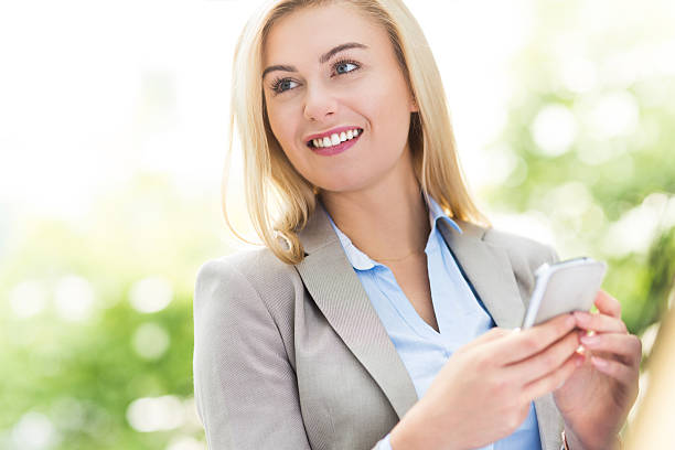 istock Young woman holding mobile phon 521028751