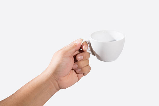 istock Hand holding a cup of coffee isolated on white 521028993