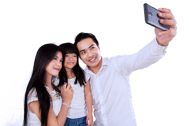 istock Hispanic family taking self portrait 521029153