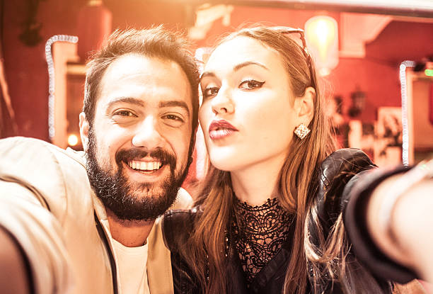 istock Young couple in love taking selfie 521029383