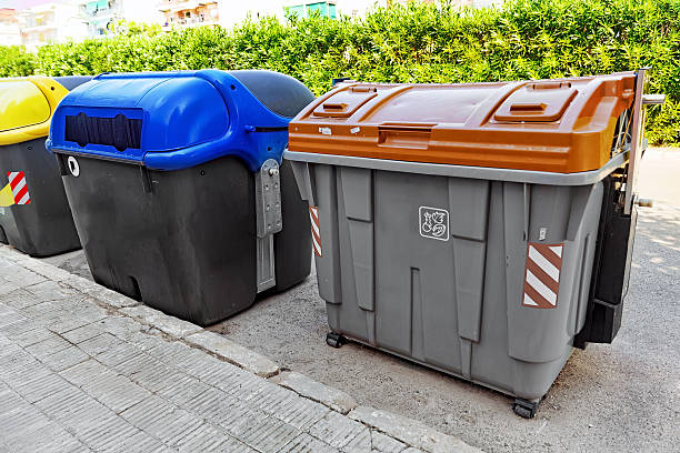 istock Variety dumpsters(recycling containers ) on a city street. 521029729