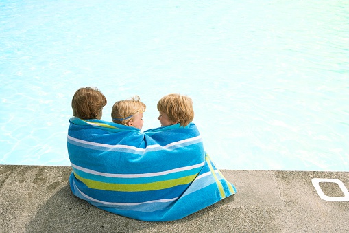 Children wrapped in a beach towel
