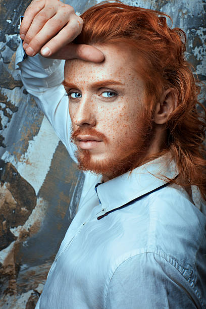 Red-haired man with a beard and mustache in a white shirt metrosexual.