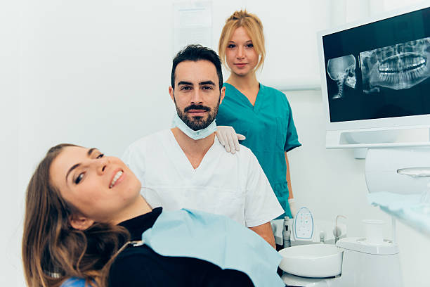 istock dentist doctor with the assistant in the clinic 521034112