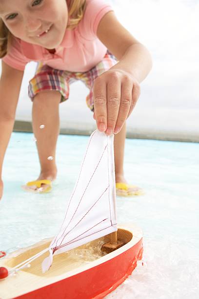 Toy sailboat and plastic turtle in a swimming pool