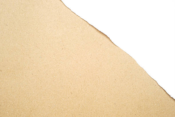 istock torn white paper on brown cardboard paper 521035118