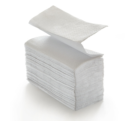 Paper napkins and towels in closeup on white