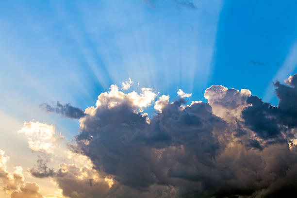 Clouds In The Blue Sky and Sun Rays stock photo