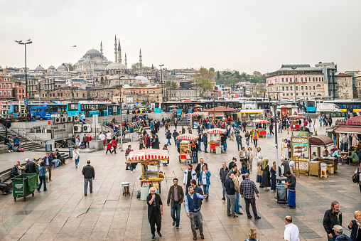Istanbul, Turkey - April 08, 2016: People are walking on the coast of Eminonu where sellers selling turkish fast food  in Istanbul, Turkey