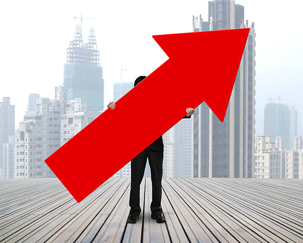 istock standing businessman holding red arrow sign 521038619
