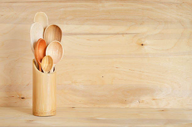 istock Spoons in a bamboo container on a wooden board background. 521039070