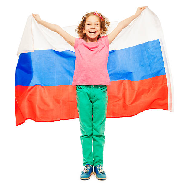 istock Cute curly-haired girl waving a Russian flag 521039464