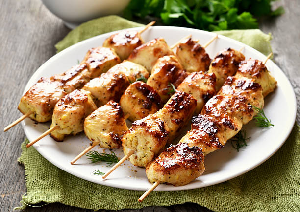 Grilled chicken on bamboo skewers Grilled chicken on bamboo skewers, close up view, shallow depth of field skewer photos stock pictures, royalty-free photos & images