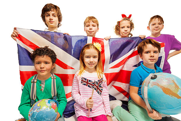 istock Seven English kids studying geography with globes 521041348