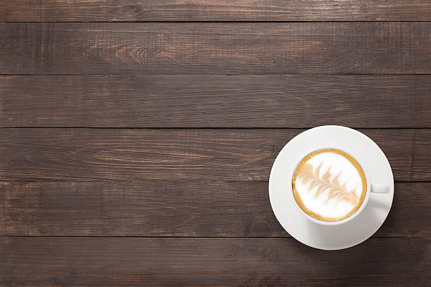 istock Coffee cup on wooden background. Top view 521041924