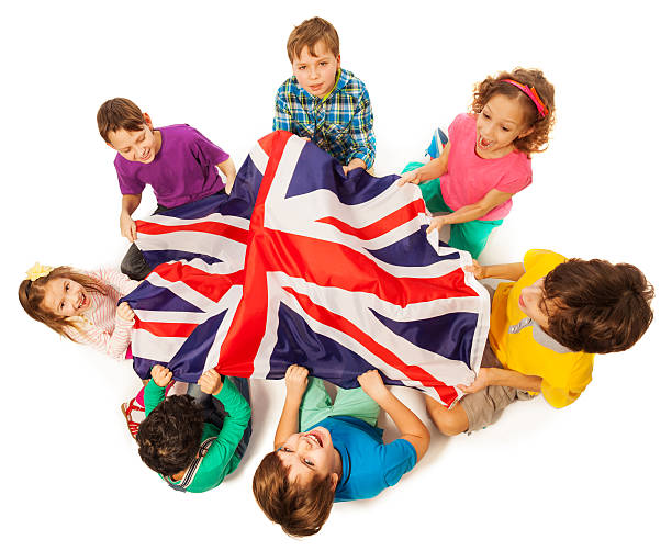 Kids with English flag in a middle of their circle stock photo