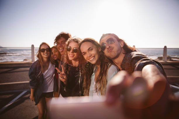 istock Hipster friends grimacing taking a selfie at the beach 521042618