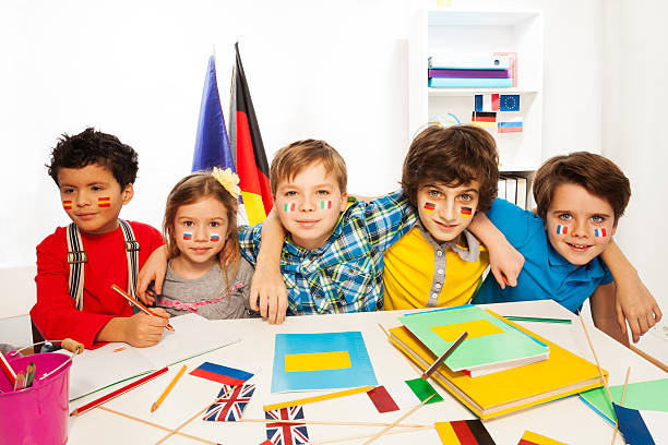 istock Kids learning languages sitting in line at a desk 521042780