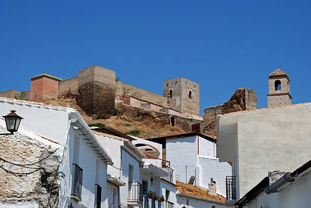 Alora, Spain - June 27, 2008: Arab castle on the top of the hill with townhouses in the foreground, Alora, Malaga Province, Andalusia, Spain, Western Europe.