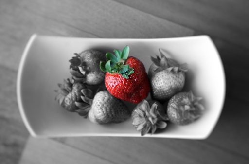 red strawberry on black and white