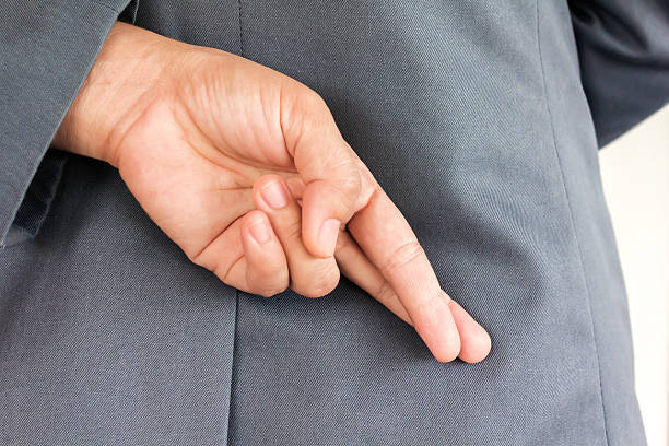 istock Making lie symbol finger hiden behind 521044772