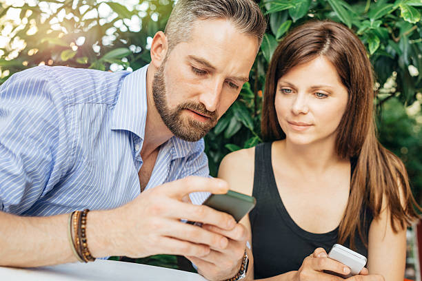 istock Young happy couple looking at mobile phone 521046146