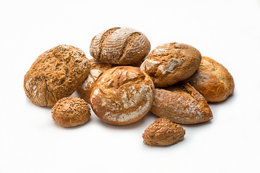 Assortment of artisan breads isolated on white background
