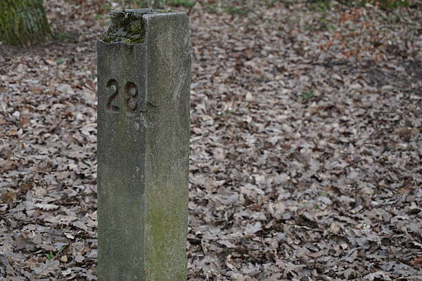 istock Aged stony milestone next to the touristy pathway 521047128