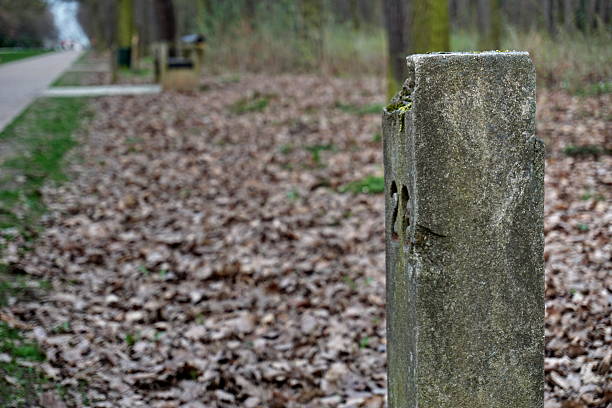Aged stony milestone next to the touristy pathway