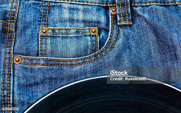 Vinyl Disc On Jeans Stock Photo - Download Image Now - 1960-1969, Arts Culture and Entertainment, Blue Background