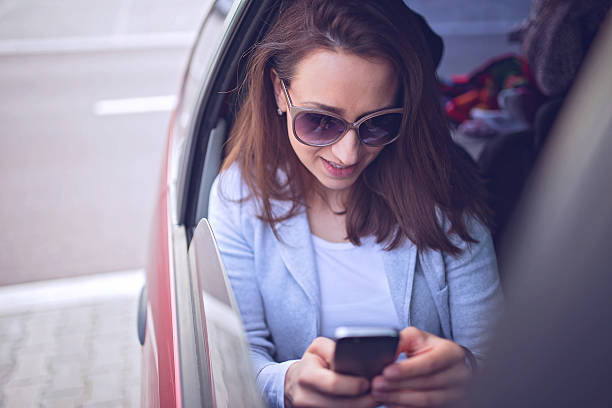istock Girl in a car texting 521047322