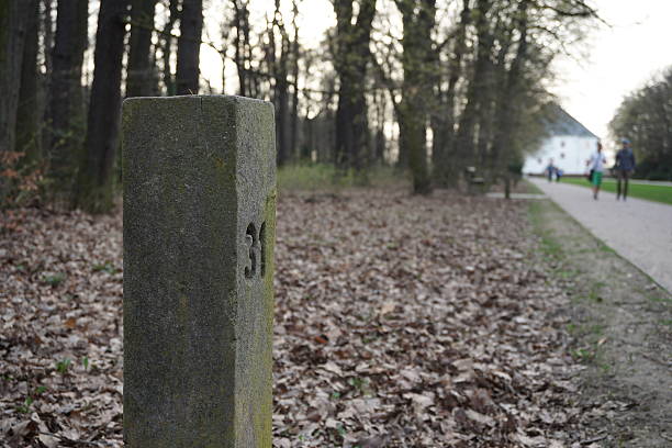 istock Aged stony milestone next to the touristy pathway 521047418
