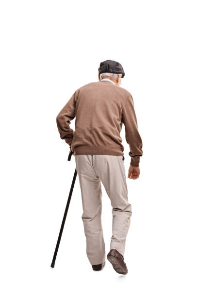 istock Old man walking with a black cane 521047696