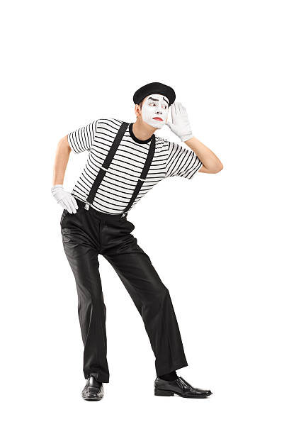 Male mime artist trying to hear something Vertical shot of a male mime artist trying to hear something isolated on white background pantomime stock pictures, royalty-free photos & images