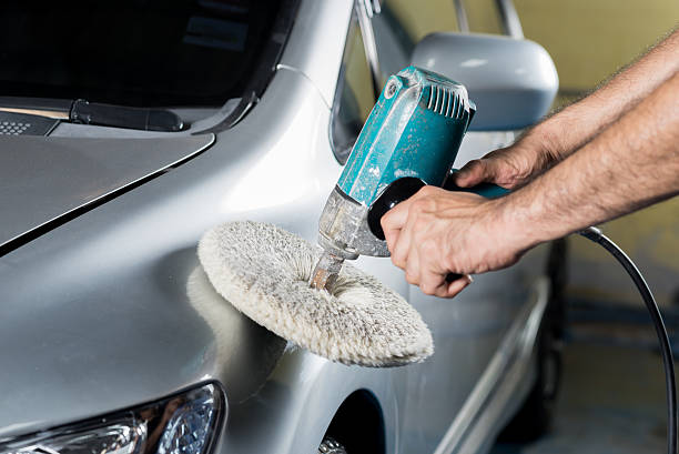 istock Car detailing series : Worker waxing gray car 521048264