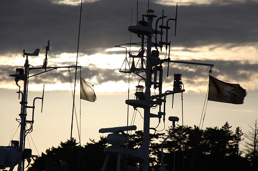 Ship masts with a sunset background. 