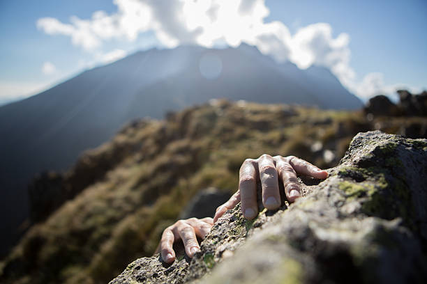 istock Hands reaching top of mountain peak 521048641