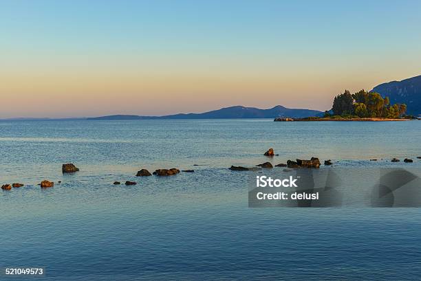 Sunset Behind The Pontikonisi Island At Corfu Greece Stock Photo - Download Image Now