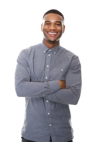 Portrait of a cheerful african american man smiling with arms crossed on isolated white background