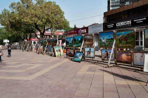 Almaty, Kazakhstan - May 6, 2014: Pedestrian zone street Jibek Joly. Arbat Shopping street is a nice place to visit when visiting Almaty, as it's filled with artists selling their works, People walk on the street